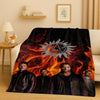 A dark, fiery graphic featuring a stylized sun emblem and several men in dark clothing on a blanket.