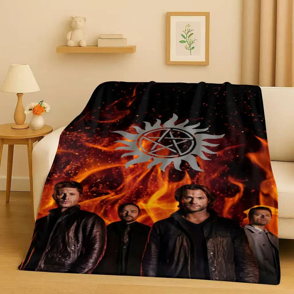 A dark, fiery graphic featuring a stylized sun emblem and several men in dark clothing on a blanket.