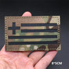 A close-up of a tactical patch featuring the American flag design in camouflage fabric.