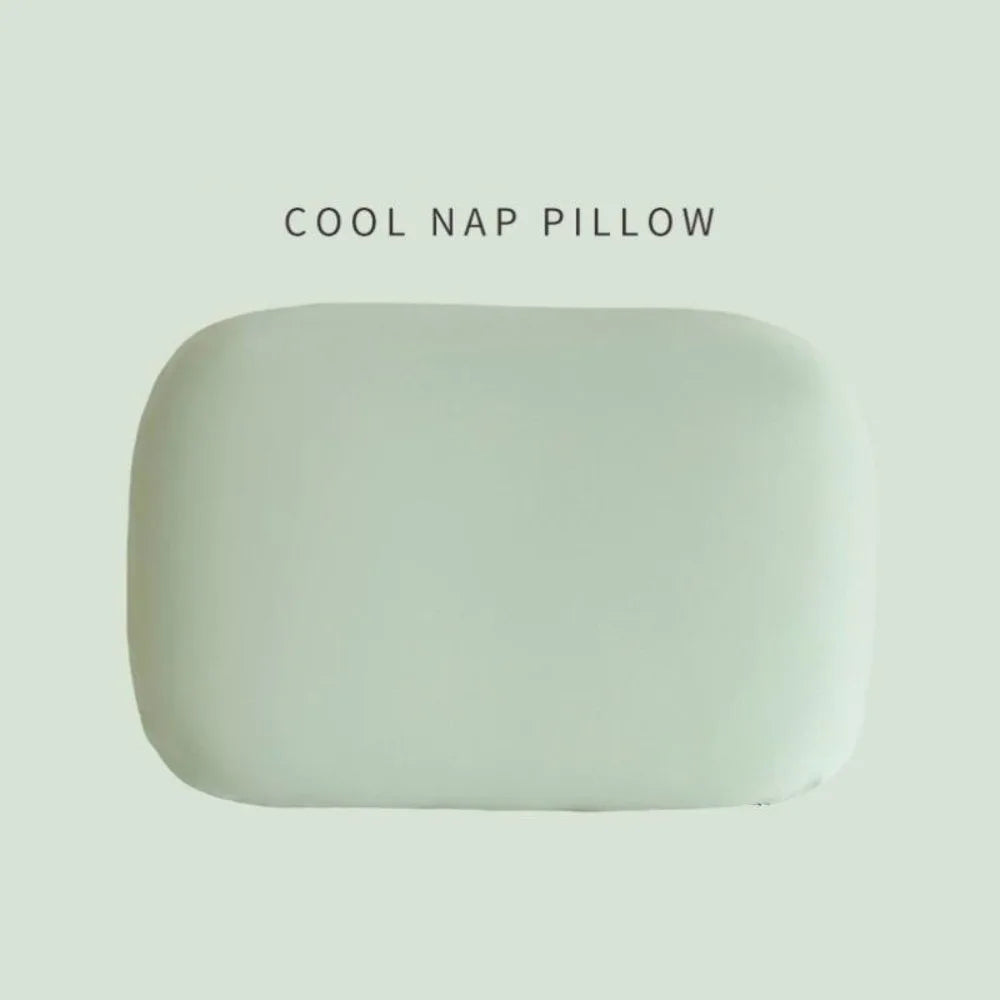 A smooth, oval-shaped, light green memory foam nap pillow.