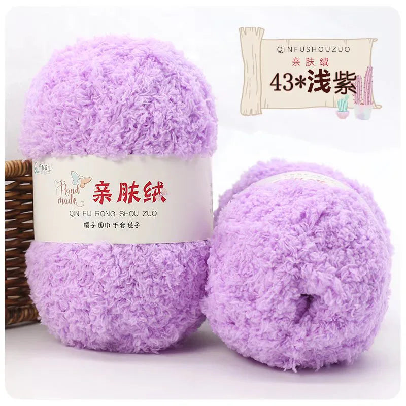 A purple ball of soft coral velvet yarn labeled as Qinfushouzuo for crafting.