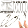 A collection of stainless steel safety pins in various sizes laid out for display.