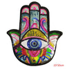 A handprint iron-on patch featuring a colorful blue eye design made with sequins.