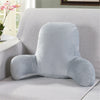 A light blue plush lumbar support cushion with arms resting on a light gray sofa.