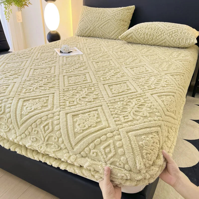 A beige plush jacquard mattress cover is shown on a bed, with decorative pillows nearby.