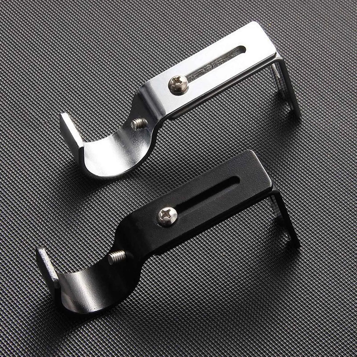 A silver adjustable iron curtain rod rack is shown against a dark background.