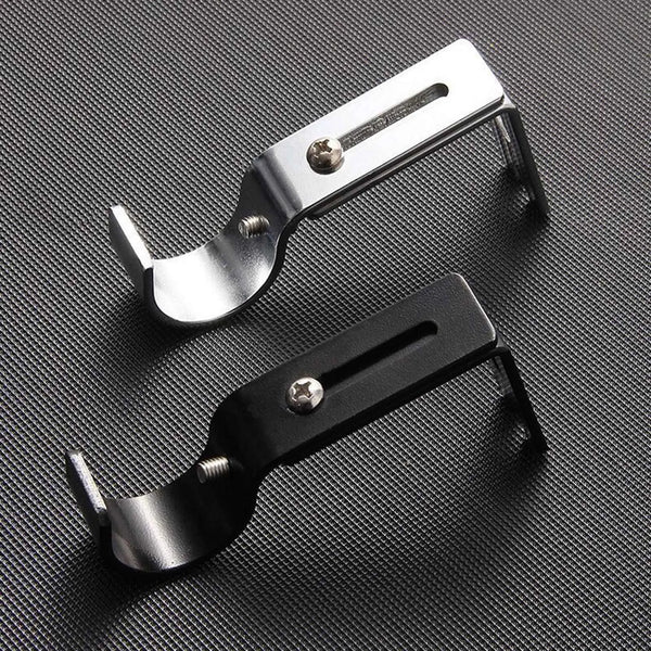 A silver adjustable iron curtain rod rack is shown against a dark background.