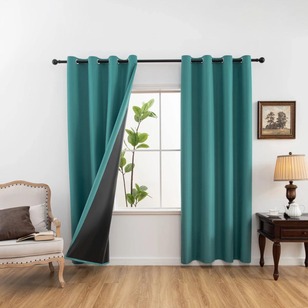 Solid teal blackout privacy curtains hanging in a window frame with a potted plant visible.