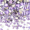 A pile of iridescent purple and gold glass rhinestones for DIY crafts