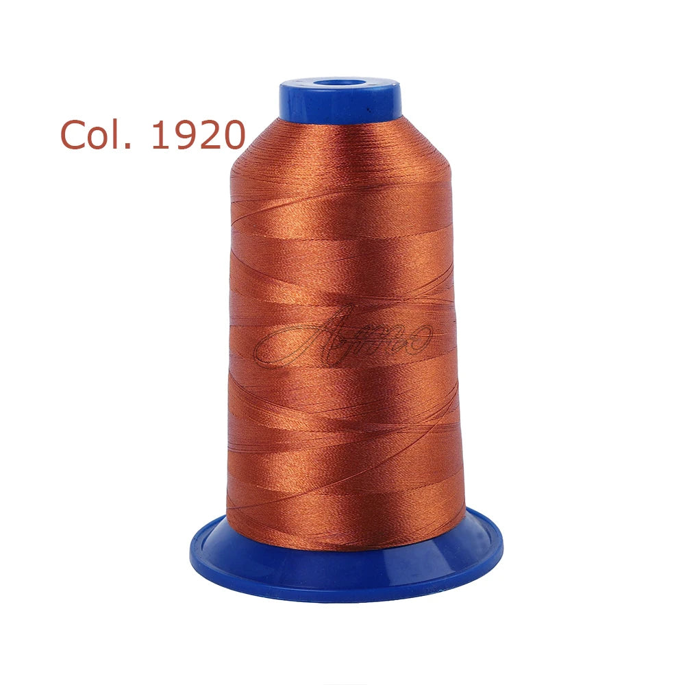 A spool of orange embroidery thread labeled Col. 1920 on a blue spindle.
