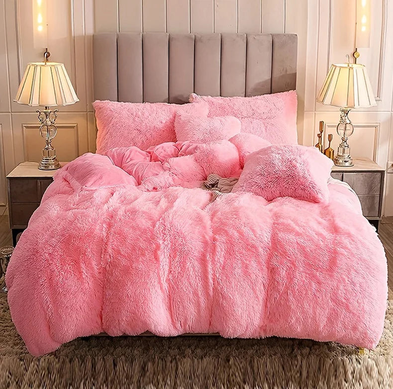 A fluffy pink plush duvet cover set displayed on a bed with a padded headboard and bedside tables.