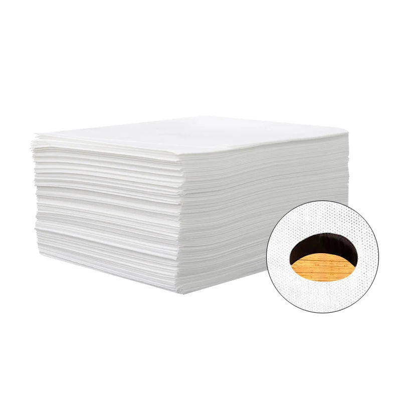 A stack of white disposable non-woven beauty and salon sheets with a circular view showing the sheet material.