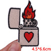Embroidered letter iron-on patch featuring a flame and a heart design on a light beige fabric.