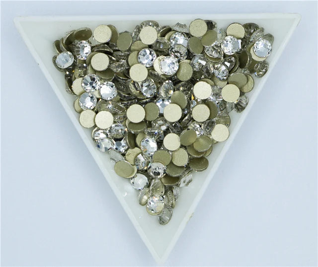 A heart-shaped arrangement of silver and clear crystal rhinestones for crafts and decor.