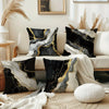 Black and gold marble print decorative pillow covers on a beige sofa with natural light.