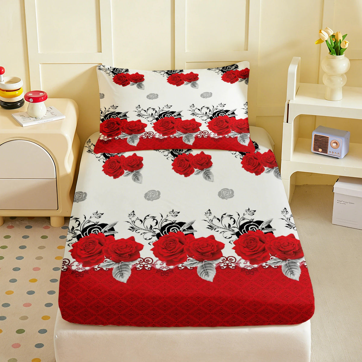 A fitted mattress cover featuring a white background with a romantic red rose print and decorative floral patterns.