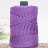 Purple crochet ice rope for DIY crafts coiled on a light brown surface.