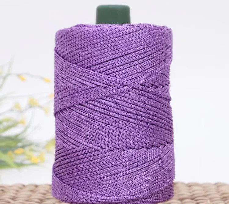 Purple crochet ice rope for DIY crafts coiled on a light brown surface.