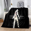 A black flannel throw blanket featuring a white and purple retro printed design of a man.