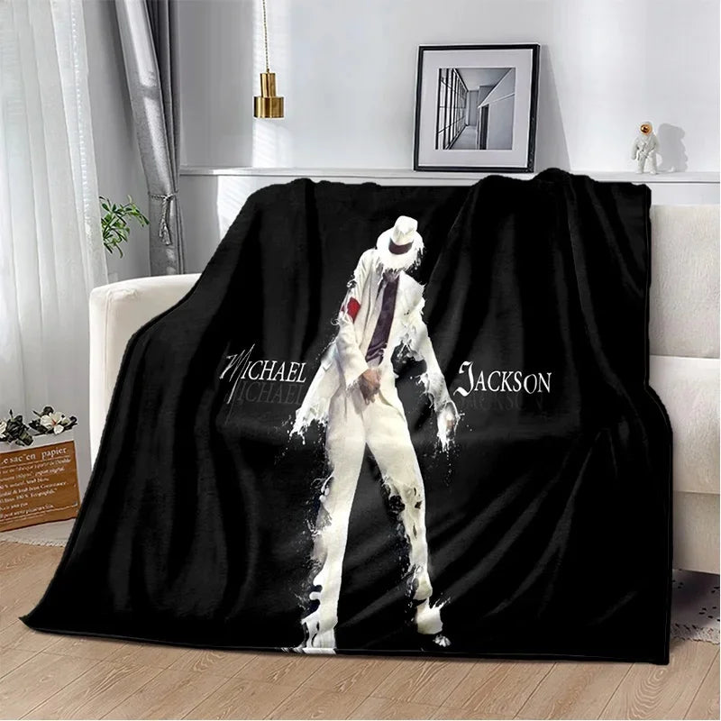 A black flannel throw blanket featuring a white and purple retro printed design of a man.