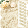 A beige boho gauze table runner with white braided accents and floral greenery.