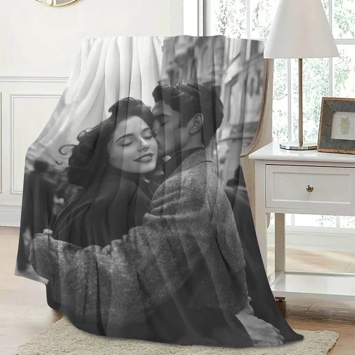 A personalized photo blanket featuring a black and white portrait of a couple embracing.