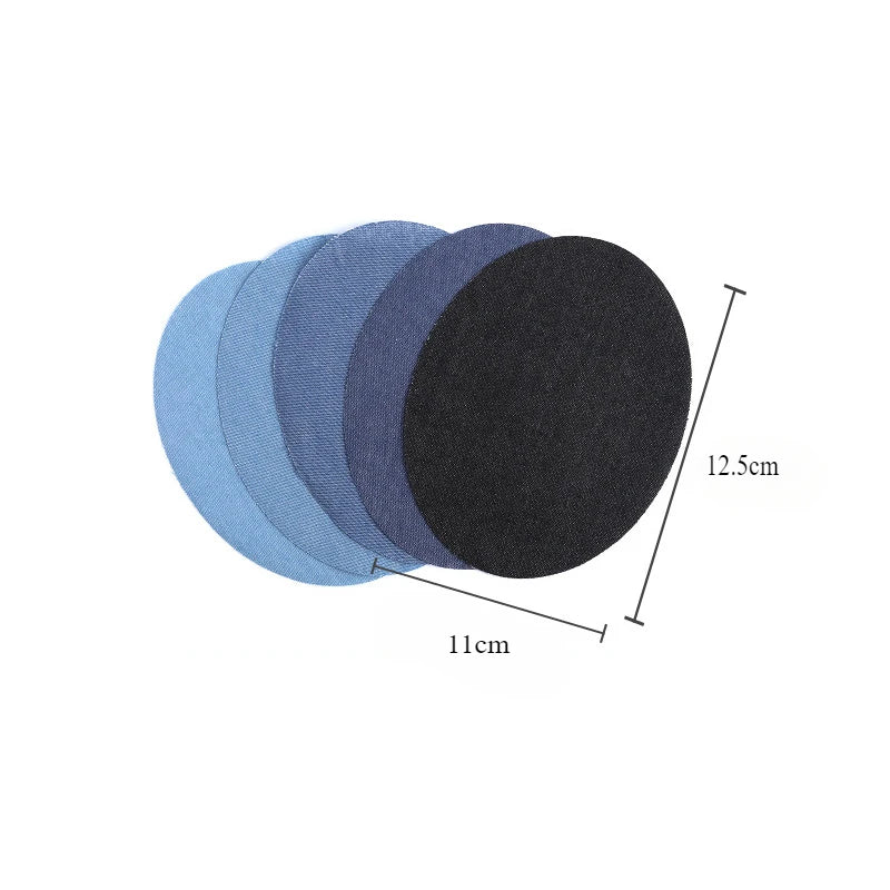 A stack of round iron-on cotton patches in various shades of blue and black, showing their size.