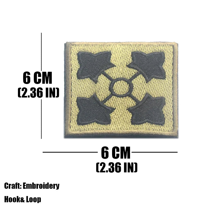 A square embroidered tactical patch with a gray design featuring four star shapes on a beige fabric.