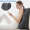 A woman is using a memory foam wedge pillow for back support and leg elevation.