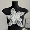 Silver sequin lace applique fabric patches shaped like a multi-petaled flower displayed on a black mannequin.