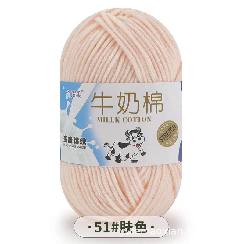 A ball of pink milk cotton yarn labeled in Chinese and English for knitting