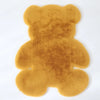 A fluffy, golden brown bear-shaped non-slip area rug.