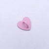 A small, pink metal heart charm connector for phone cases.