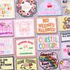 A collection of embroidered letter slogan patches featuring phrases like Girl Power No Weenies Allowed and Coastal Cowgirl