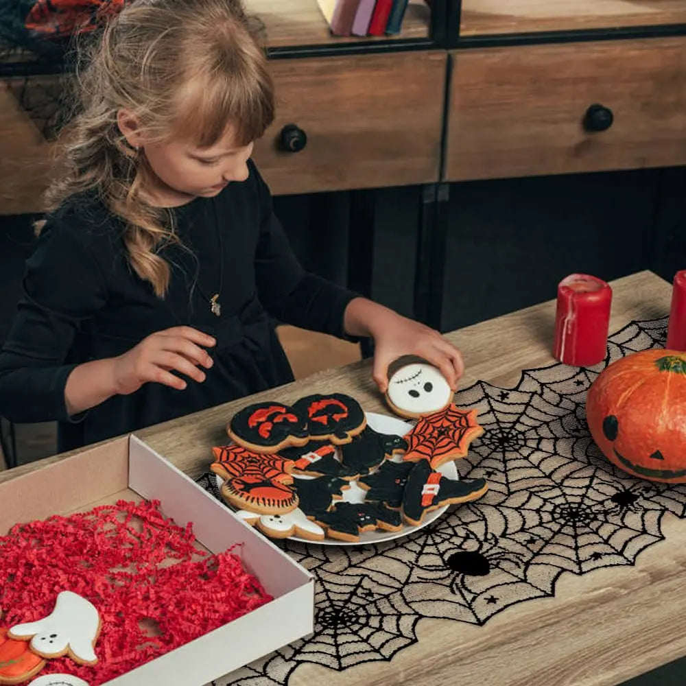 A table runner featuring a black lace spider web design for Halloween decor.