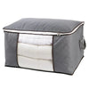 A gray portable quilt and clothing storage bag with a quilted exterior and white lining.