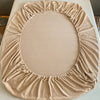 A beige luxury velvet bedding set featuring a ruffled, oval-shaped cover.