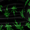 A close-up of black fitted sheet fabric featuring a green cannabis leaf print.