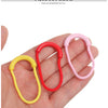 Three U-shape zipper pull straps in red, pink, and yellow are displayed on a hand.