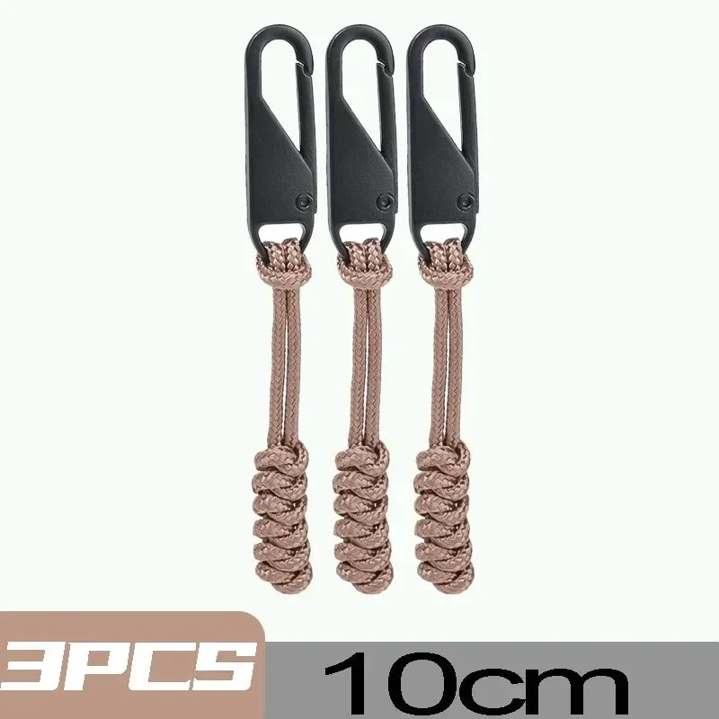 Three black detachable zipper pull sliders with beige cord for bags and clothing