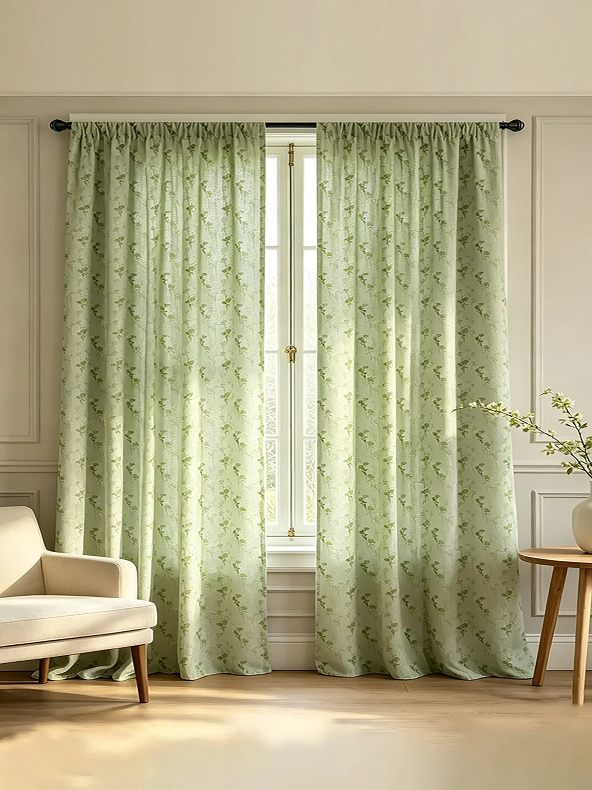 Light sage green floral print curtains hanging in a white window frame with natural light filtering through.