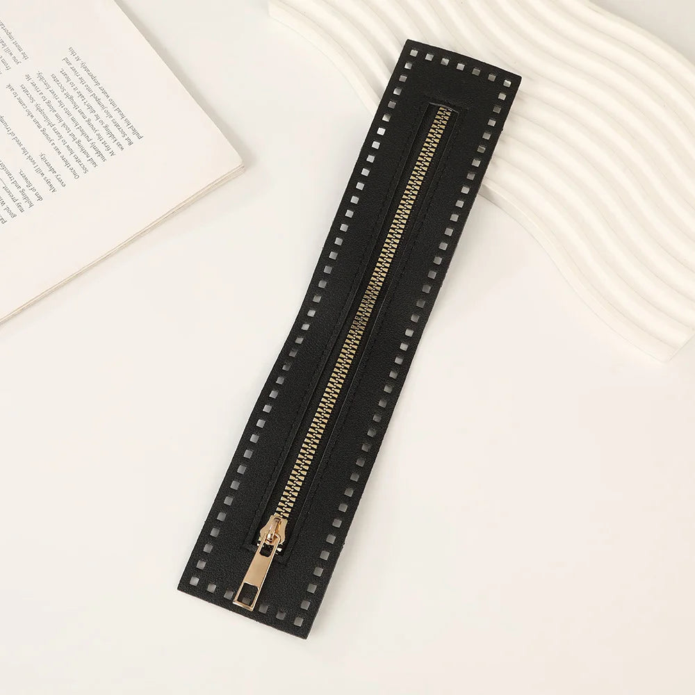 A black PU leather zipper frame with studs is shown on a white surface.