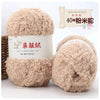 A pair of fluffy, light brown coral velvet yarn balls for crafting.