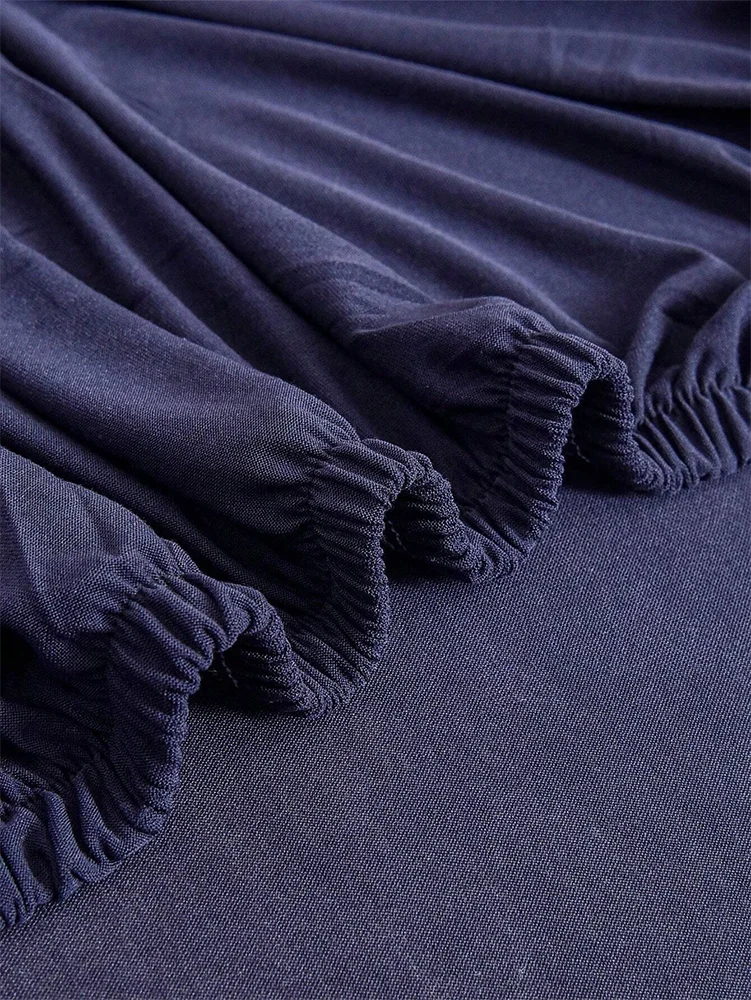 Dark navy elastic sofa slipcover fabric gathered at the cuff