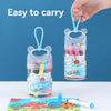 A hand is holding a clear plastic container of washable art markers for kids, demonstrating its easy to carry design.
