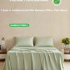 A flat sheet made from bamboo fiber in a light green color is displayed on a bed.