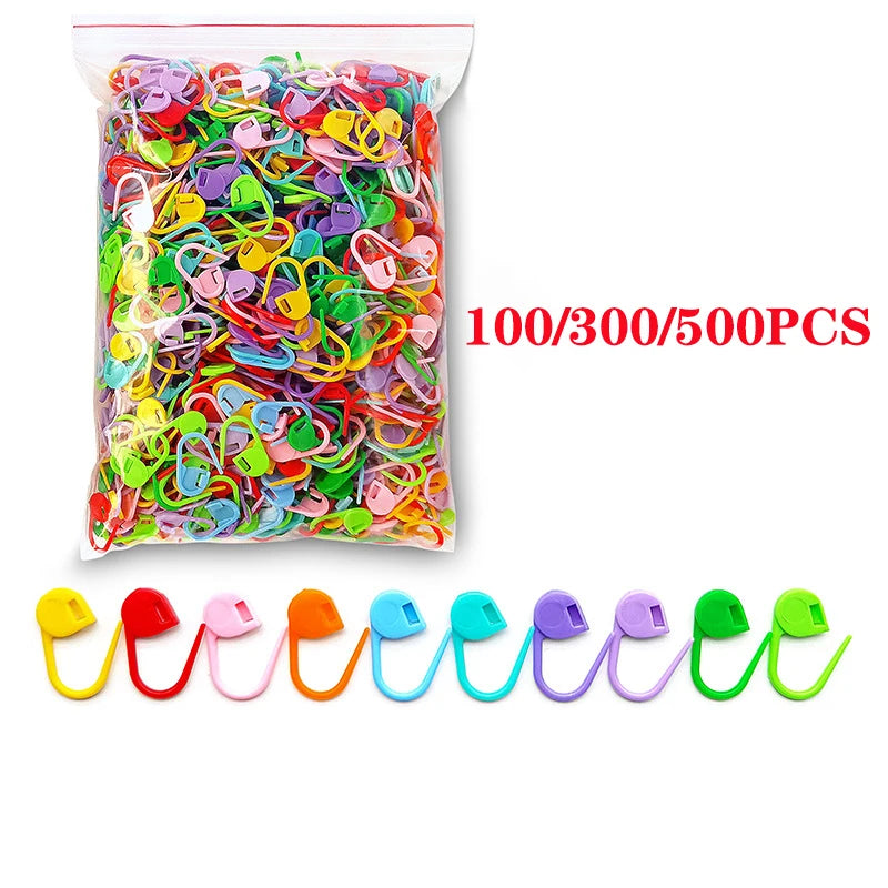 A plastic bag filled with colorful stitch markers for knitting and crochet, available in 100, 300, or 500 pieces.