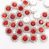 Silver and red crystal rhinestone sew-on buttons arranged in a floral pattern