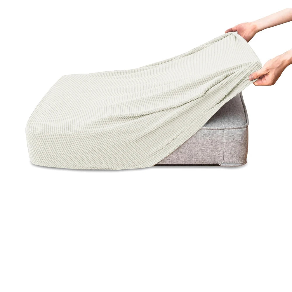A light beige polar fleece jacquard sofa seat cushion cover being held by a hand.