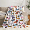 A colorful fabric blanket featuring various cartoon dog illustrations in shades of brown, yellow, pink, and blue.